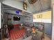 Cozy cabana features comfortable seating, a TV, and a fire pit for ultimate relaxation and entertainment at 13850 Royston Bnd, Hudson, FL 34669