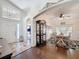 Spacious foyer with tile flooring, leading to a dining room with hardwood floors and elegant decor at 13850 Royston Bnd, Hudson, FL 34669