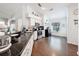 Well-lit kitchen featuring black granite countertops, stainless steel appliances, and hardwood flooring at 13850 Royston Bnd, Hudson, FL 34669