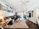 Spacious living room with hardwood floors, comfortable seating, and large windows for natural light at 13850 Royston Bnd, Hudson, FL 34669