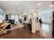 Bright open living room with hardwood floors, modern furniture, and large windows with access to a screened patio at 13850 Royston Bnd, Hudson, FL 34669