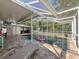 Outdoor screened pool with covered seating, decorative lights, and patio, perfect for relaxation and entertainment at 13850 Royston Bnd, Hudson, FL 34669
