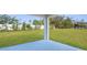 Expansive backyard featuring green grass, white fence, and a covered patio at 14042 Amero Ln, Spring Hill, FL 34609