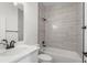 Modern bathroom with white vanity, sleek white countertops, a large mirror, and a beautifully tiled shower at 14042 Amero Ln, Spring Hill, FL 34609