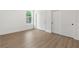 This bedroom has light hardwood floors and closet space at 14042 Amero Ln, Spring Hill, FL 34609