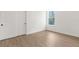 Bedroom features wood-look floors, a window, and a double-door closet at 14042 Amero Ln, Spring Hill, FL 34609