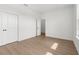 Bright bedroom with wood-look floors, white walls, closet, and natural light at 14042 Amero Ln, Spring Hill, FL 34609