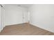 Bedroom with wood-look floors, white walls, and a white door and closet at 14042 Amero Ln, Spring Hill, FL 34609