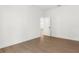 Empty bedroom features wood-look floors, a white door, and neutral paint at 14042 Amero Ln, Spring Hill, FL 34609