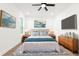 This bedroom offers a large bed with nightstands, dresser and art, providing an inviting space at 14042 Amero Ln, Spring Hill, FL 34609