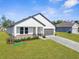 This home has a gray garage door and a well-manicured lawn at 14042 Amero Ln, Spring Hill, FL 34609