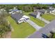Aerial view of a modern house with green yard, concrete driveway, gray roof, and a seamless attached garage at 14042 Amero Ln, Spring Hill, FL 34609
