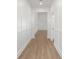 Long hallway with wood-look flooring and modern trim on the walls at 14042 Amero Ln, Spring Hill, FL 34609