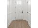 This hallway has light hardwood floors and white wainscotting at 14042 Amero Ln, Spring Hill, FL 34609