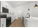 This kitchen has white cabinets, stainless steel appliances, and a black faucet at 14042 Amero Ln, Spring Hill, FL 34609