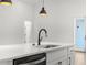 This kitchen island features a stainless steel dishwasher and black faucet at 14042 Amero Ln, Spring Hill, FL 34609