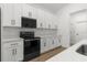 Modern kitchen featuring white cabinets, stainless steel appliances, and plenty of counter space at 14042 Amero Ln, Spring Hill, FL 34609