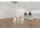 Open-concept living room and kitchen with white cabinets and light hardwood floors at 14042 Amero Ln, Spring Hill, FL 34609