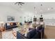 Open concept living with hardwood floors, living room area, dining space, and modern kitchen with island at 14042 Amero Ln, Spring Hill, FL 34609