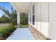 Charming covered front porch with decorative columns and stone accents, adding character and curb appeal at 14042 Amero Ln, Spring Hill, FL 34609