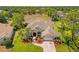 Stunning aerial view of a beautifully landscaped property with a long driveway and a well-maintained lawn at 14163 Andrew Scott Rd, Spring Hill, FL 34609