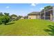Well-manicured backyard with lush green lawn, offering a serene and private outdoor space at 14163 Andrew Scott Rd, Spring Hill, FL 34609