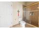 Bathroom featuring a toilet and a glass door shower with tiled walls at 14163 Andrew Scott Rd, Spring Hill, FL 34609