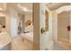 Luxurious bathroom featuring a jetted tub, walk-in shower and elegant travertine tile at 14163 Andrew Scott Rd, Spring Hill, FL 34609