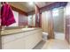 Bathroom with a tan countertop, vanity with a mirror, tile floors, and a shower with a bathtub at 14163 Andrew Scott Rd, Spring Hill, FL 34609