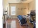 Cozy bedroom featuring wood floors, a mirror, and a window at 14163 Andrew Scott Rd, Spring Hill, FL 34609