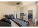 Bedroom with two large monitors, wood floors, and a view of the closet and another bedroom at 14163 Andrew Scott Rd, Spring Hill, FL 34609
