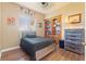 Bedroom with a bed, wood floors, a large cabinet with display space, and a dresser at 14163 Andrew Scott Rd, Spring Hill, FL 34609