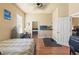 Bedroom featuring wood floors, a ceiling fan, a television, and mirrored closet at 14163 Andrew Scott Rd, Spring Hill, FL 34609