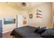 Bedroom with wood floors, a bed, and a TV on the wall at 14163 Andrew Scott Rd, Spring Hill, FL 34609