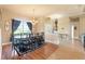 Elegant dining room with hardwood floors, decorative lighting, and large windows at 14163 Andrew Scott Rd, Spring Hill, FL 34609