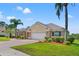 Inviting home with brick-accented facade, paver driveway, and lush landscaping at 14163 Andrew Scott Rd, Spring Hill, FL 34609