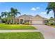 Charming home featuring a well-manicured lawn, beautiful landscaping and brick accents at 14163 Andrew Scott Rd, Spring Hill, FL 34609