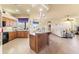 Open kitchen with center island, granite countertops and wooden cabinetry at 14163 Andrew Scott Rd, Spring Hill, FL 34609