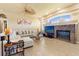 Bright living room with a ceiling fan, tile flooring, and a brick fireplace at 14163 Andrew Scott Rd, Spring Hill, FL 34609