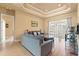 Bright living room with hardwood floors, tray ceiling and large sliding glass doors at 14163 Andrew Scott Rd, Spring Hill, FL 34609