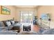 Comfortable living room with hardwood floors, large windows, and an entertainment setup at 14163 Andrew Scott Rd, Spring Hill, FL 34609