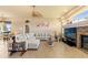 Bright living room with a comfortable sectional sofa, tile flooring and a brick fireplace at 14163 Andrew Scott Rd, Spring Hill, FL 34609