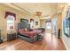 Spacious main bedroom suite featuring hardwood floors, a fan, and private seating at 14163 Andrew Scott Rd, Spring Hill, FL 34609