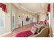 Spacious main bedroom suite featuring hardwood floors, a fan, private seating, and an exterior door at 14163 Andrew Scott Rd, Spring Hill, FL 34609