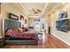 Spacious main bedroom suite featuring hardwood floors, a fan, private seating, and exterior access at 14163 Andrew Scott Rd, Spring Hill, FL 34609