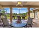 Covered patio with ceiling fan and a lake view, providing a perfect outdoor dining spot at 14163 Andrew Scott Rd, Spring Hill, FL 34609