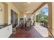 Covered patio with brick flooring, a ceiling fan, an outdoor kitchen, and a clear view of a backyard at 14163 Andrew Scott Rd, Spring Hill, FL 34609