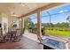 Screened patio with a view of the backyard, a fire pit, and an outdoor kitchen with two grills at 14163 Andrew Scott Rd, Spring Hill, FL 34609