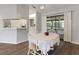Cozy dining area with wood floors, adjacent to the kitchen and living space at 1452 Haulover Ave, Spring Hill, FL 34608