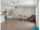 Bright and airy living room featuring wood floors, ceiling fan, and neutral decor at 1452 Haulover Ave, Spring Hill, FL 34608
